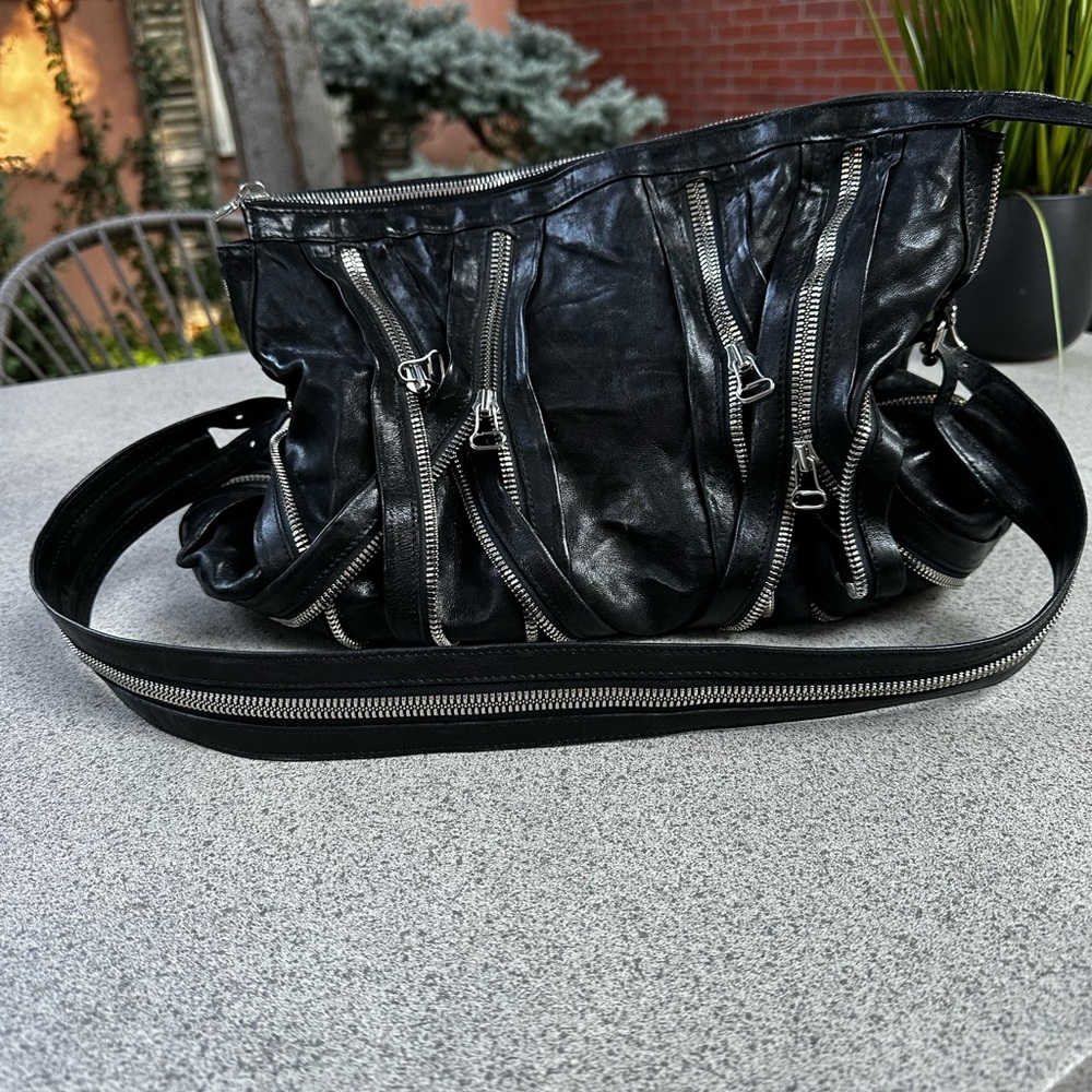Vintage Balmain black leather bag with silver zippers. Worn once